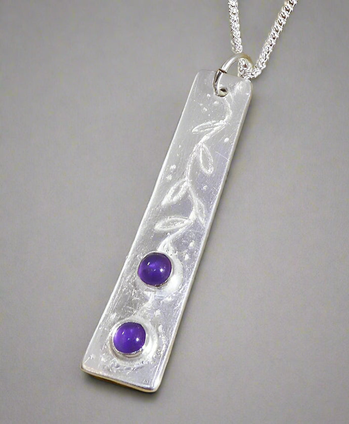 Jane Vernon Fine silver long thin pendant set with two amethyst cabochons